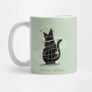 Cartoon black cat in New Year's garlands and the inscription "Merry Catmas". Mug